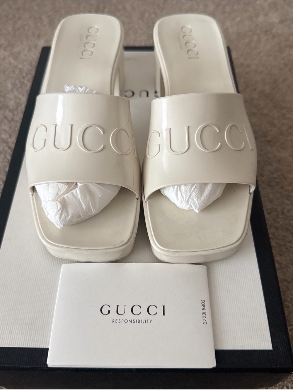 Gucci Cream Patent Slide Mules with Raised Logo
100% authentic